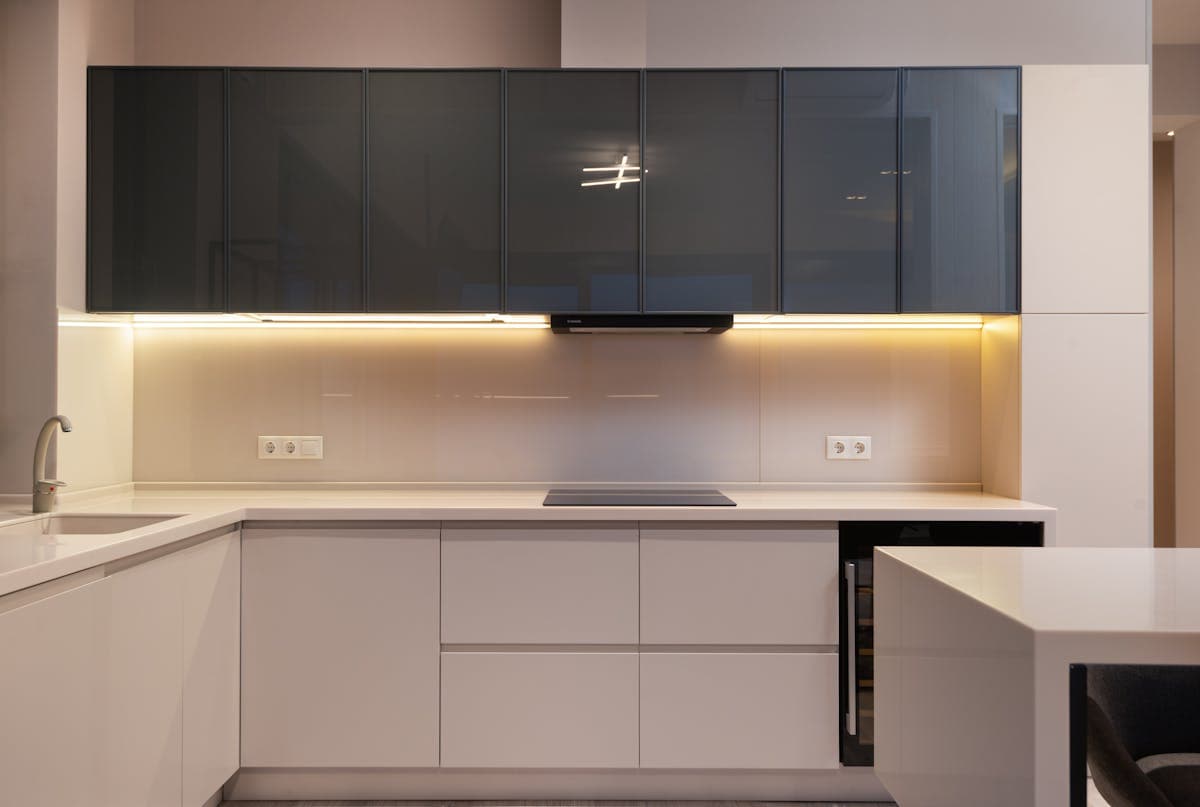 Professional kitchen fitting in South London — handleless units with LED lighting and quartz worktop