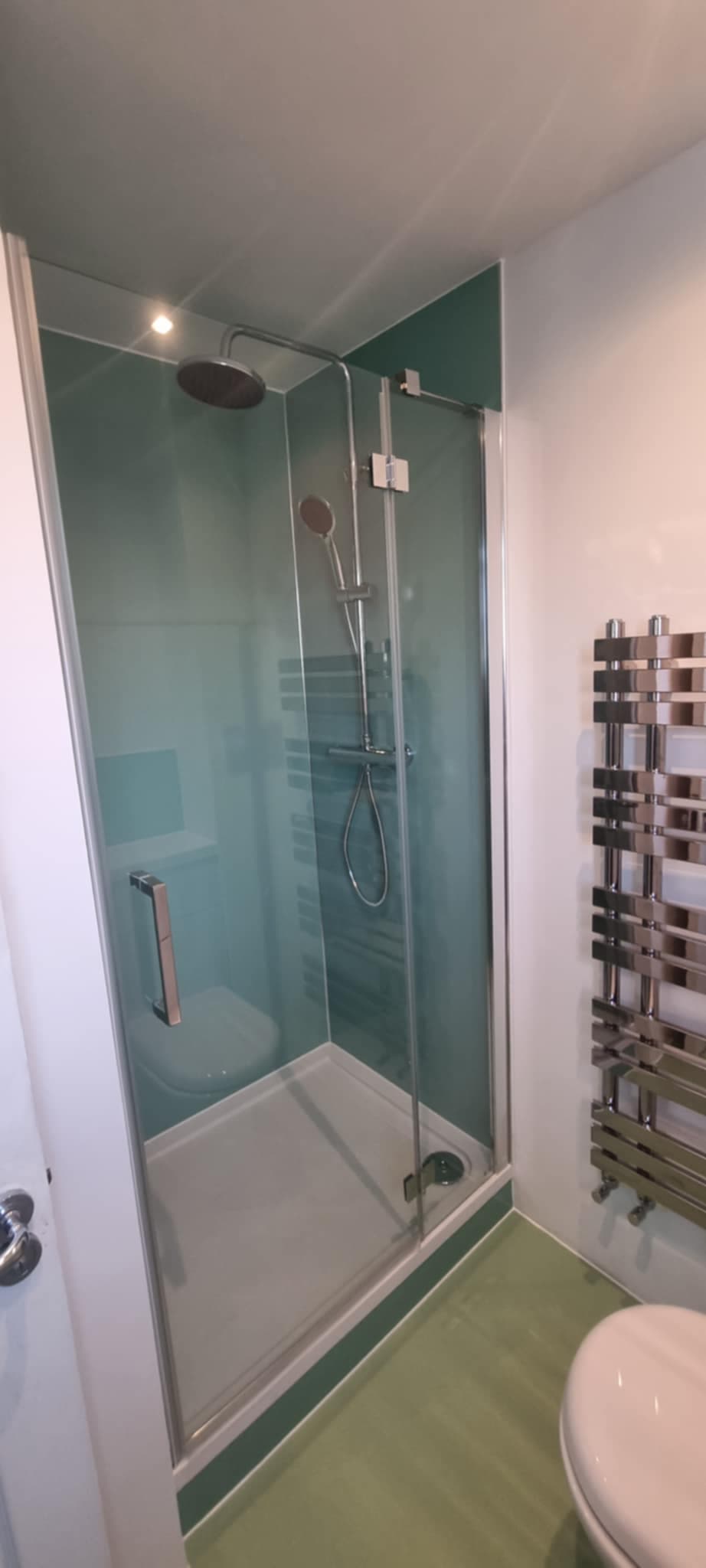 Teal glass shower enclosure