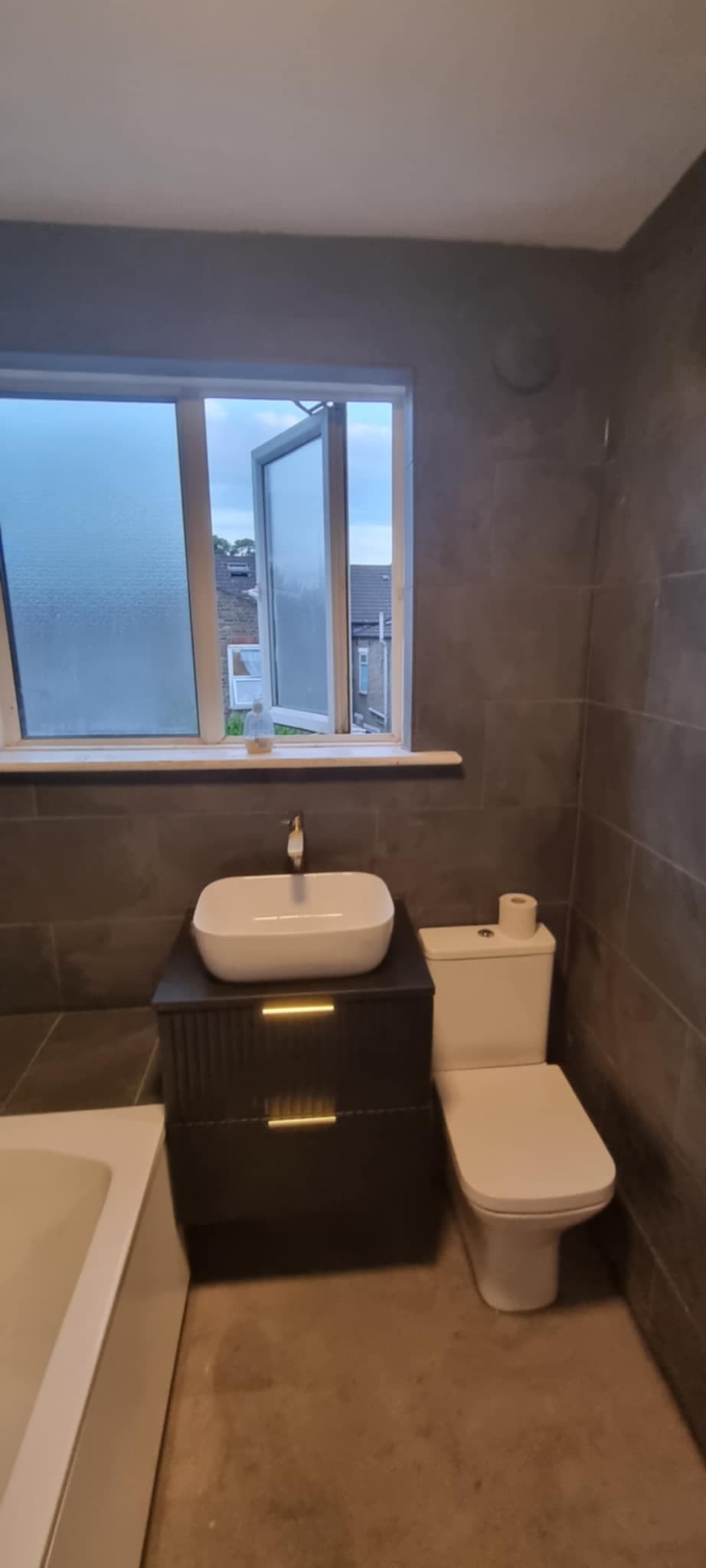 Dark bathroom vanity unit with vessel basin installed in Kent